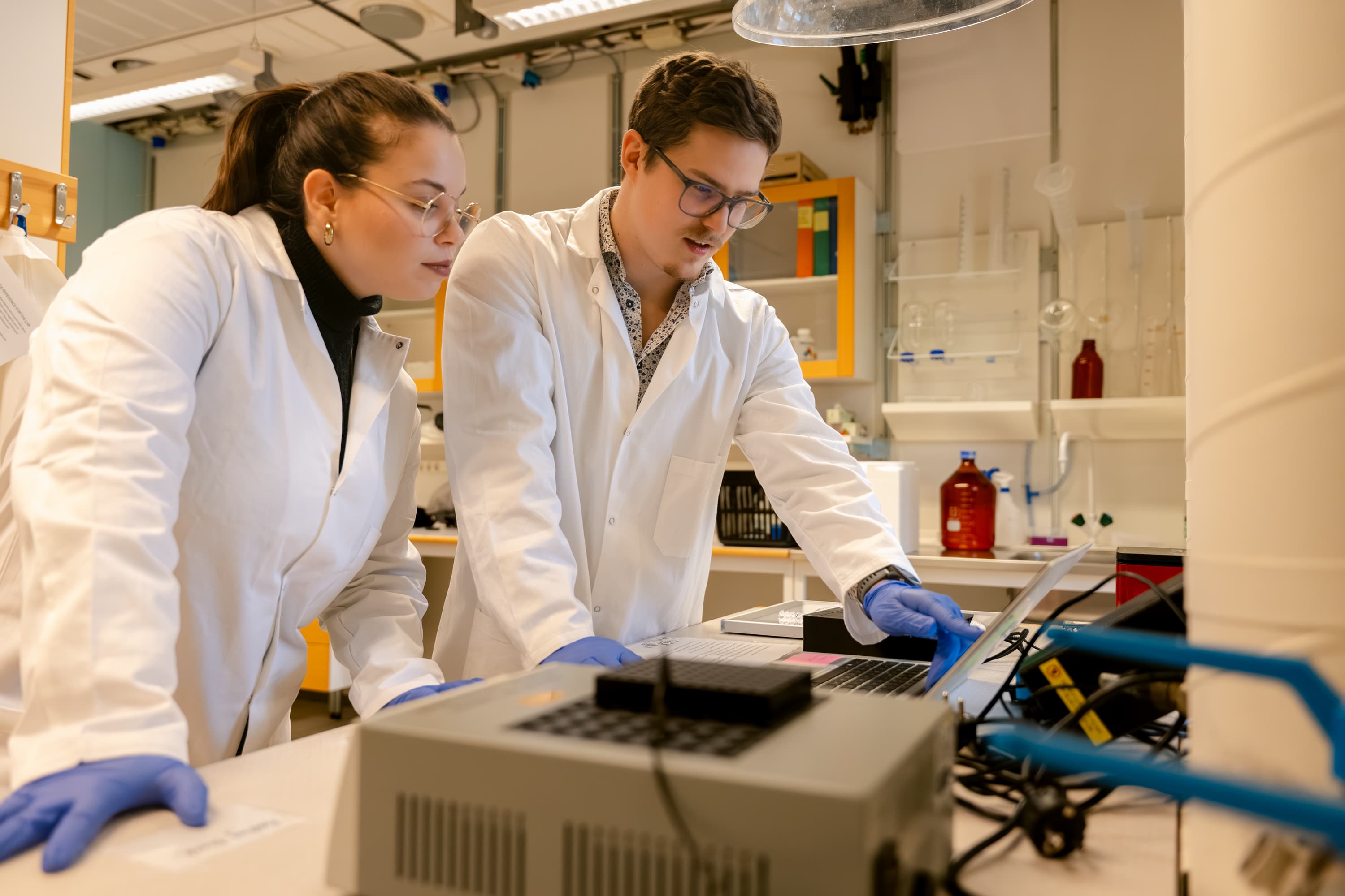 Two researchers at lab workbench